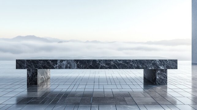 Modern dark granite bench outdoors overlooking misty mountains