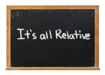 Fototapeta premium It's all relative written in white chalk on a black chalkboard