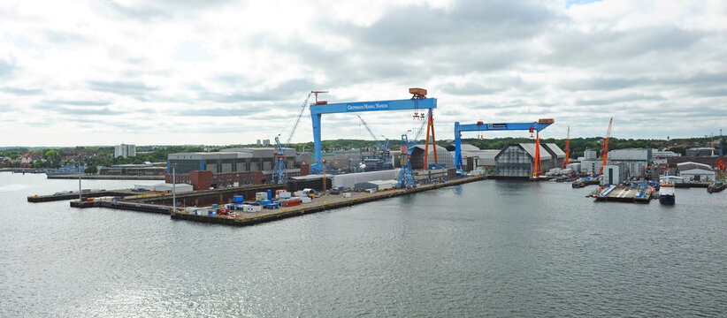 Panorama of the port of Kiel with the German Naval Shipyards and ThyssenKrupp Shipyards. Kiel is the capital of the state of Schleswig-Holstein, Germany. Gantry cranes are visible at the shipyards.