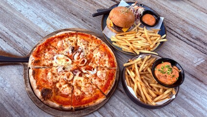Pizza , hamburger and french fries , lunch time.