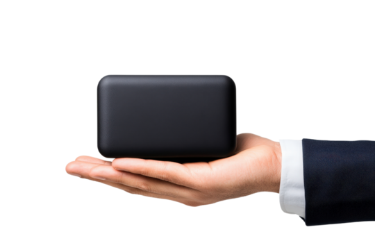 Businessman s hand holding a sleek minimalist technology or electronic gadget box showcasing a new product or innovation for a corporate or professional workspace setting