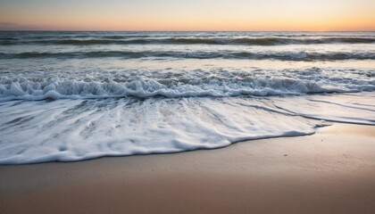 Obraz premium Serene Sunset Waves Crashing on Sandy Beach Coastal Serenity at Dawn