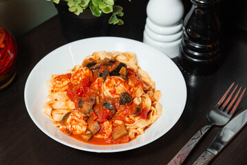 Shrimp tagliatelle pasta with tomato sauce.