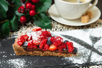 Slice of berry tart with chocolate filling.