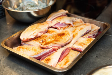 Raw duck breast fillets prepared for cooking.