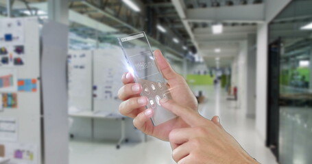 In office hallway, person interacting with futuristic transparent smartphone screen