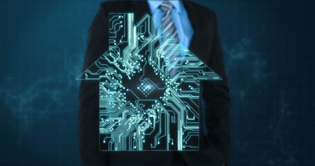 Businessman in suit standing behind digital house icon with circuit board design