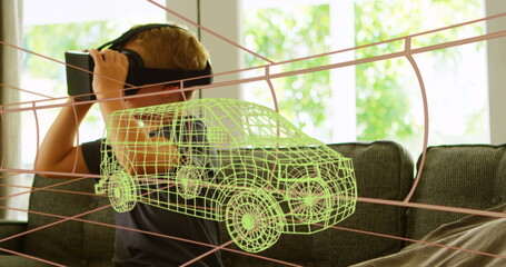 Image of 3d technical drawing of van, over boy at home wearing vr headset