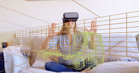 Image of 3d technical drawing of truck, over woman at home wearing vr headset