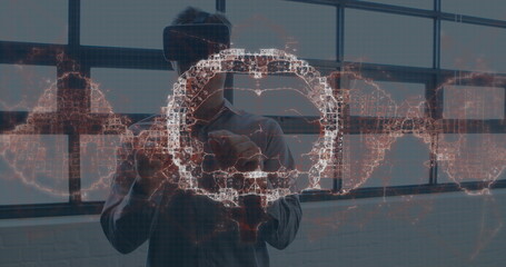 Image of human brain spinning and data processing over businessman wearing vr headset