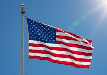 The American flag proudly waves on a bright sunny day, a vibrant symbol of freedom and patriotism against a clear blue sky.