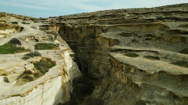 drone view flight through narrow unusual openwork porous canyon ybykty sai walls tafoni narrow rocky kazakhstan mangystau 4k