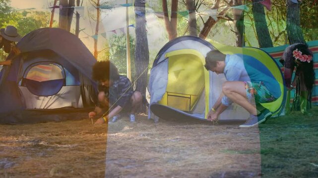 People setting up tents in forest with colorful animation overlay