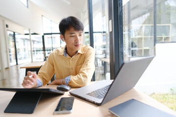 Student studying online and preparing for exams with digital devices and books
