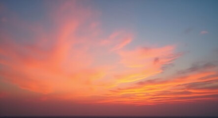 Obraz premium Stunning panoramic sunset with vibrant orange, pink, blue, and purple hues, wispy clouds, and a faint horizon, creating a serene and expansive atmosphere.