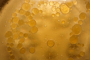 Abstract Background with Floating Bubbles in Golden Liquid Texture