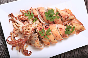 Grilled Stuffed Squid with garlic and pork. Thai style isolate on white plate