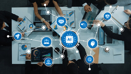 A dynamic business meeting showcasing a team collaborating on artificial intelligence strategies. Visual data and digital devices enhance decision-making in a modern office. Amity