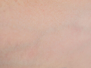 A macro shot of human skin showing the detailed structures, texture and saturation of natural hues.