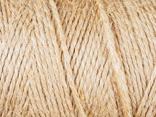 A close-up of a finely woven rope. The intricate texture and detail of the weave are clearly visible.