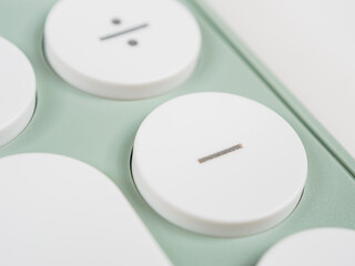 minus “-” key on a calculator, representing the subtraction operation.