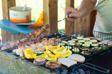 Grilling Delicious Skewers and Vegetables Outdoors on a Sunny Day in a Backyard Setting