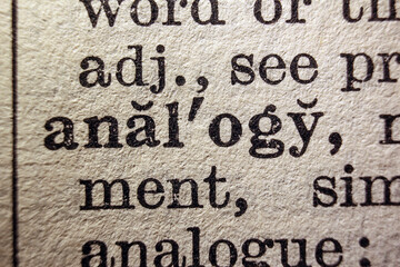 Word analogy on dictionary page, macro close-up
