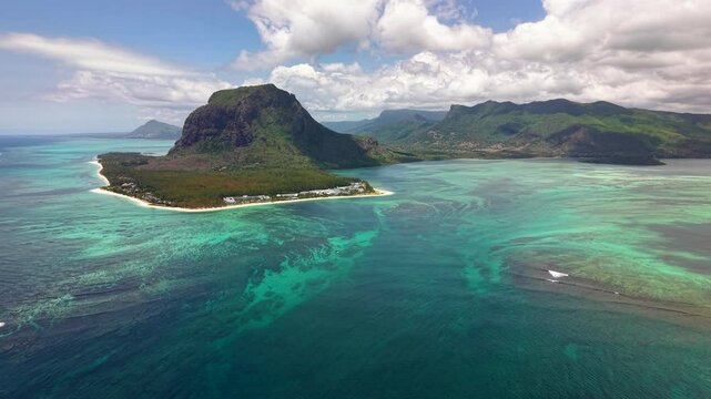 Stunning Drone Perspective of Tropical Volcanic Outcrop Rising Above Shallow Turquoise Reef Waters