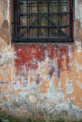 Weathered wall with peeling paint and rust stains creates a striking grunge texture
