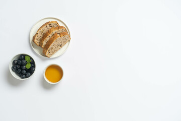 Overhead photo of nut cake with jam and orange juice.
