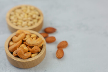 A delightful and attractive display of a variety of nuts arranged in rustic wooden bowls, perfect for healthy snacking