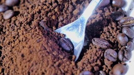 Ground coffee and whole beans on a wooden surface