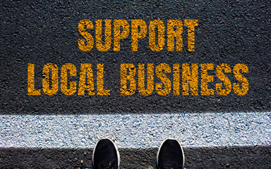 Support local business message written on asphalt road. Conceptual support local business symbol. Copy space.
