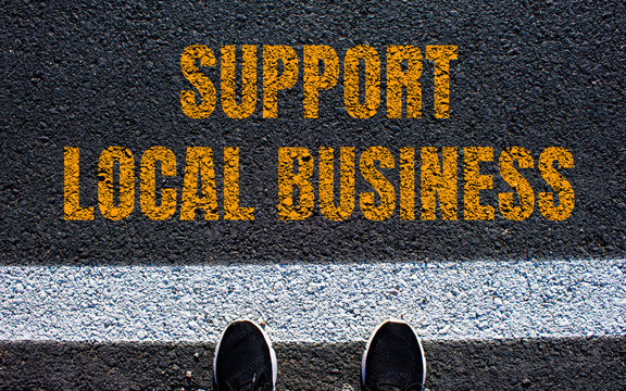 Support local business message written on asphalt road. Conceptual support local business symbol. Copy space.