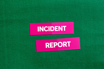 Incident report message written on pink stickers on green background. Conceptual incident report symbol. Copy space.
