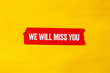 We will miss you message written on ripped torn red paper tape on yellow background. Conceptual we...