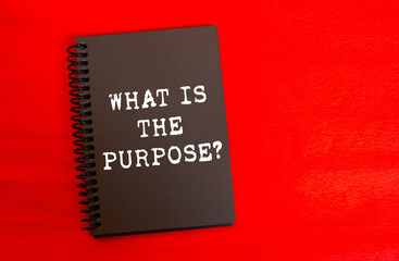 What is the purpose message written on black notebook page on red background. Conceptual what is...