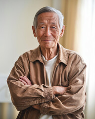 Elderly man smiling with crossed arms