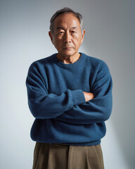 Elderly man posing in blue sweater
