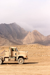 Desert Landscape With a Heavy-Duty Truck and Rugged Mountain Backdrop