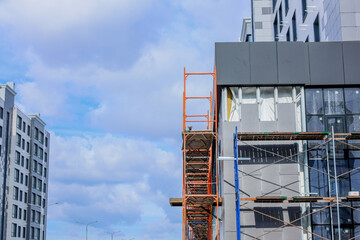 A vibrant, bustling construction site that showcases extensive scaffolding beneath a stunning, beautiful sky