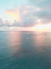Aerial view of colorful sunrise over ocean in Punta Cana. Breathtaking scenery showcases sky painted with stunning hues, while gentle waves reflect morning light. Perfect postcard capturing tropical