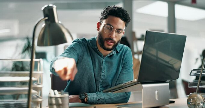 Man, laptop and typing in office with reading for ideas, research and development for project. Person, writer or editor with check, notebook and planning with process at creative agency in Colombia