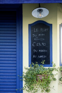 Paris, France. Europe    Cafe with sign in French that read " Plate of the day" &euro;13.90 Monday - Saturday.