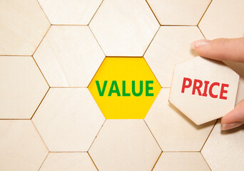 Price and Value symbol. Concept word Price and Value on wooden puzzle. Businessman hand. Beautiful...