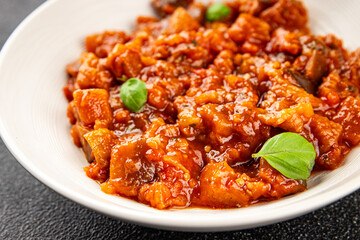 Eggplant stew vegetable dish salad tasty fresh gourmet food background on table rustic food top view copy space