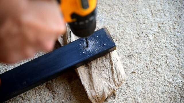 The man Use Cordless drill to drill the Square steel   