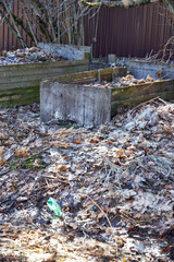 Obraz premium two large wooden leaf composters stand outside