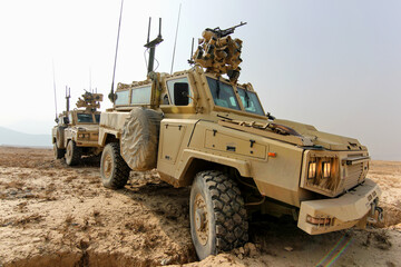 Military Vehicles on Patrol in a Desert Terrain for Security Operations