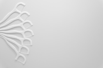 floss sticks for teeth on white background